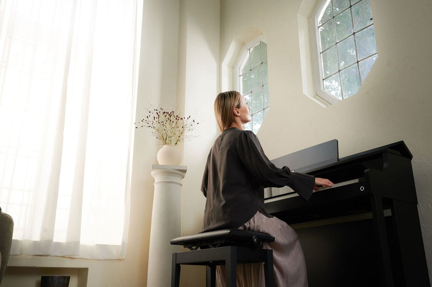 Casio AP-750BK digital piano in black – side view with a pianist.