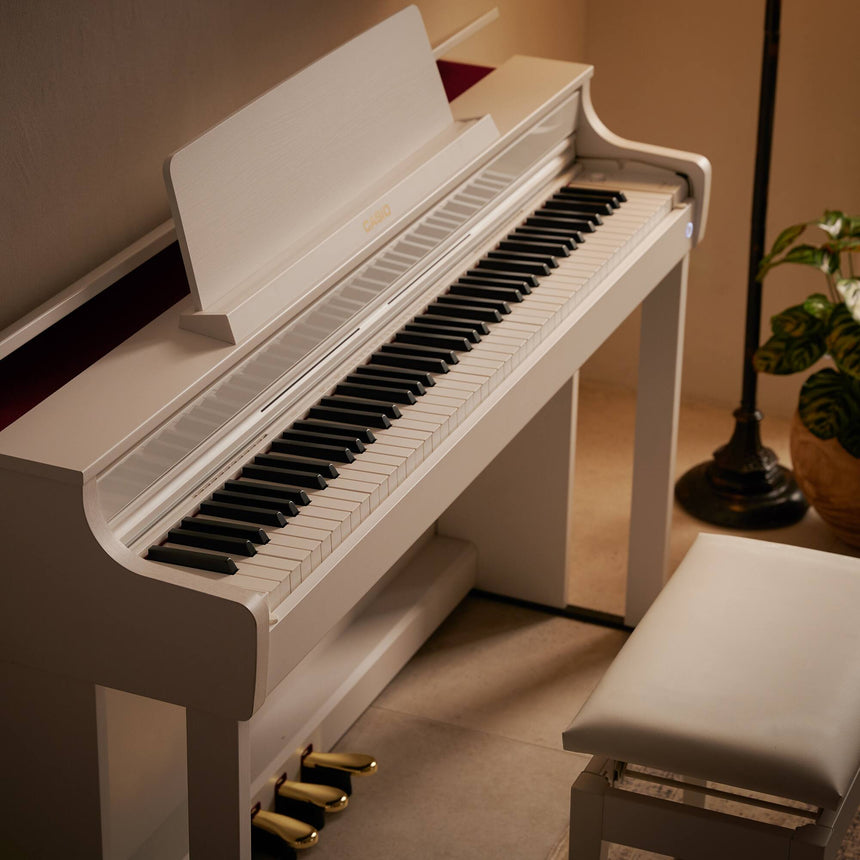 Casio AP-550WE digital piano in white – close side view of the keyboard and cabinet.